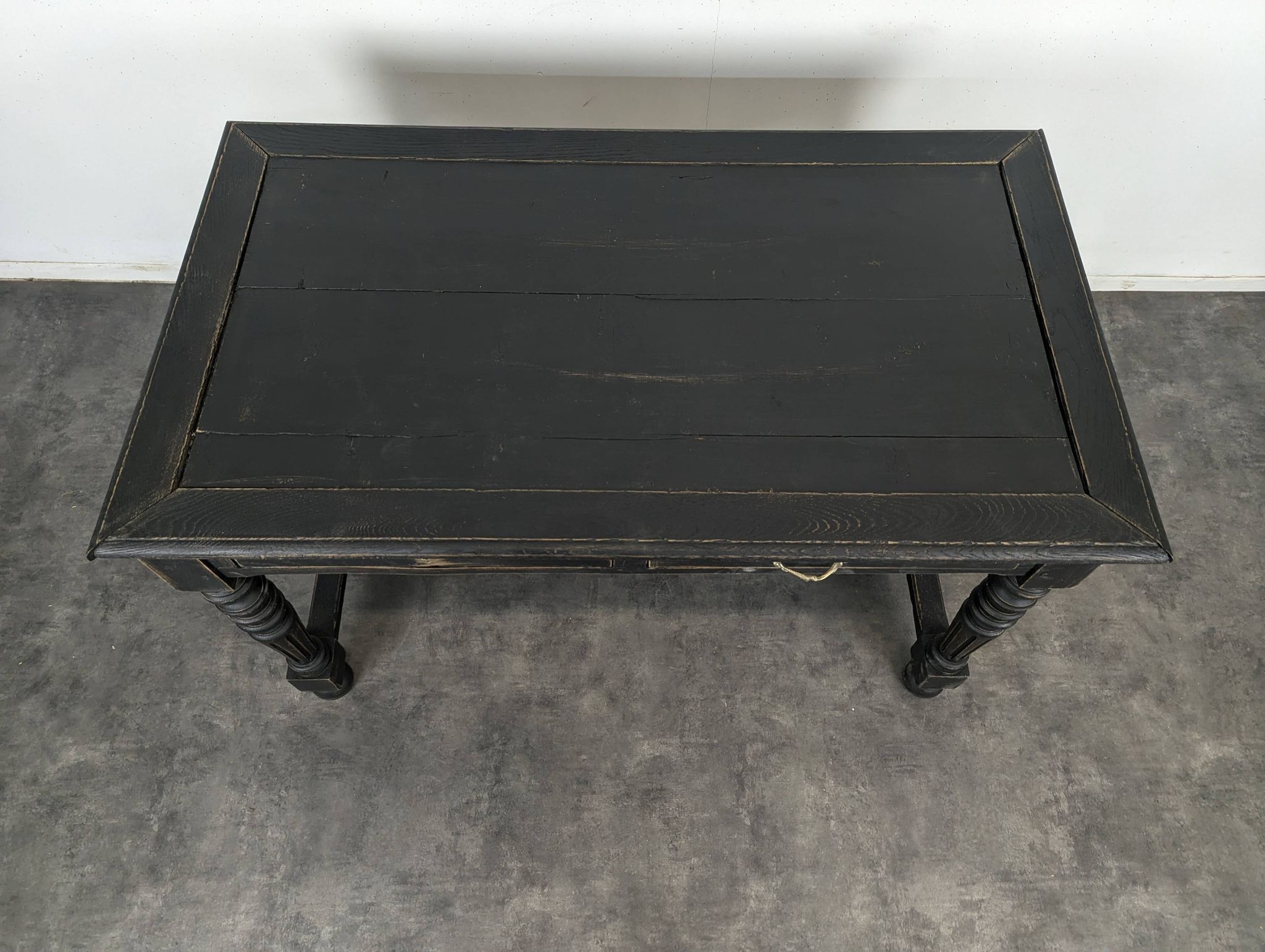 Louis XIII style desk in blackened wood with turned legs and two drawers.