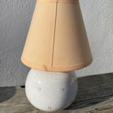 Small cracked white ceramic lamp with flowers.