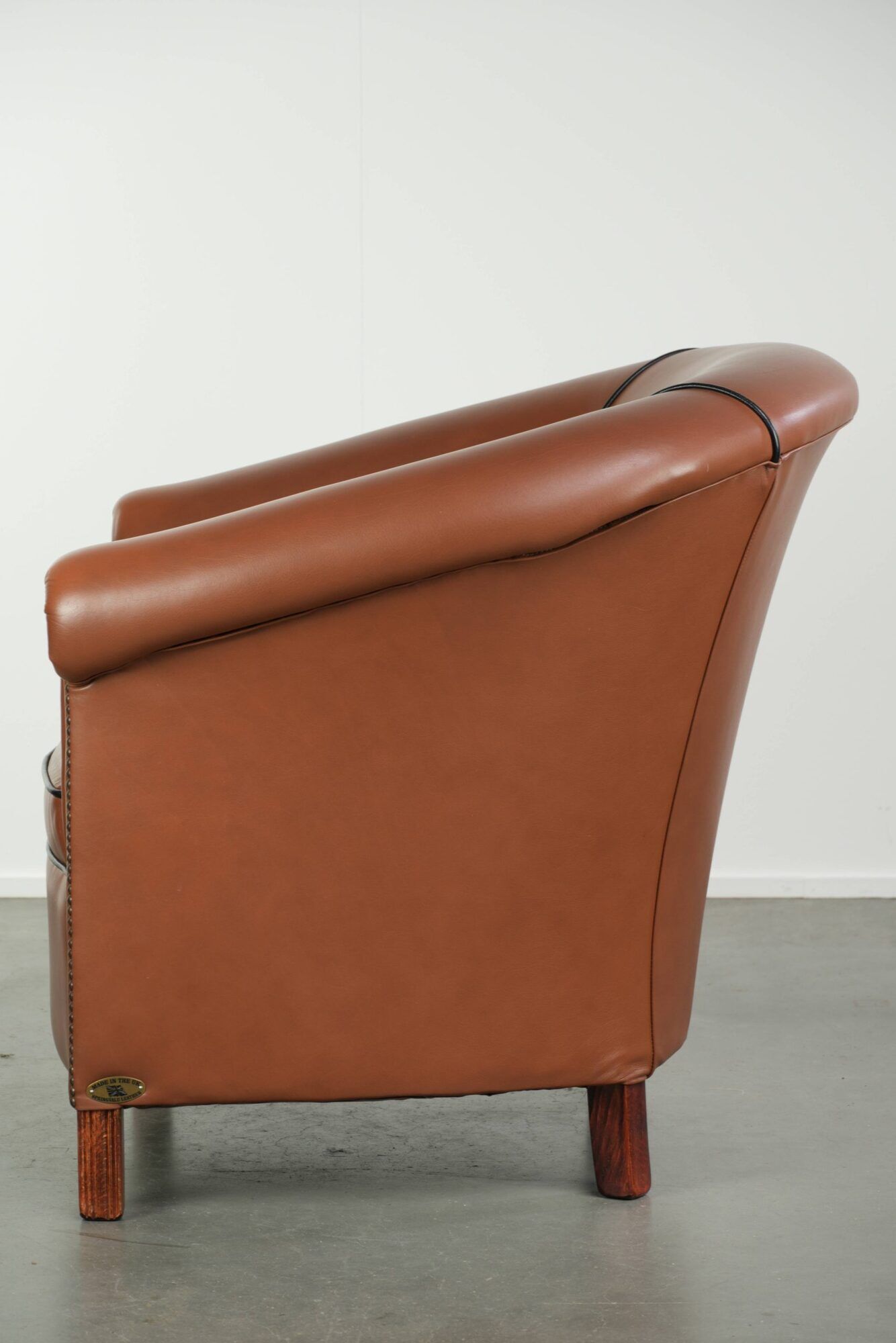 Cowhide club armchair in English style with comfortable seating.