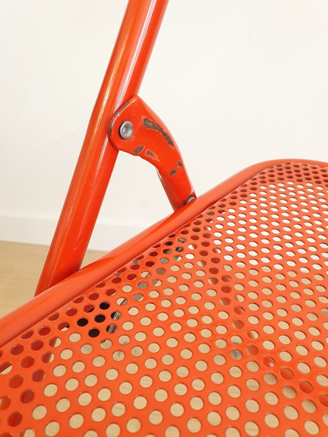 Perforated metal folding chair