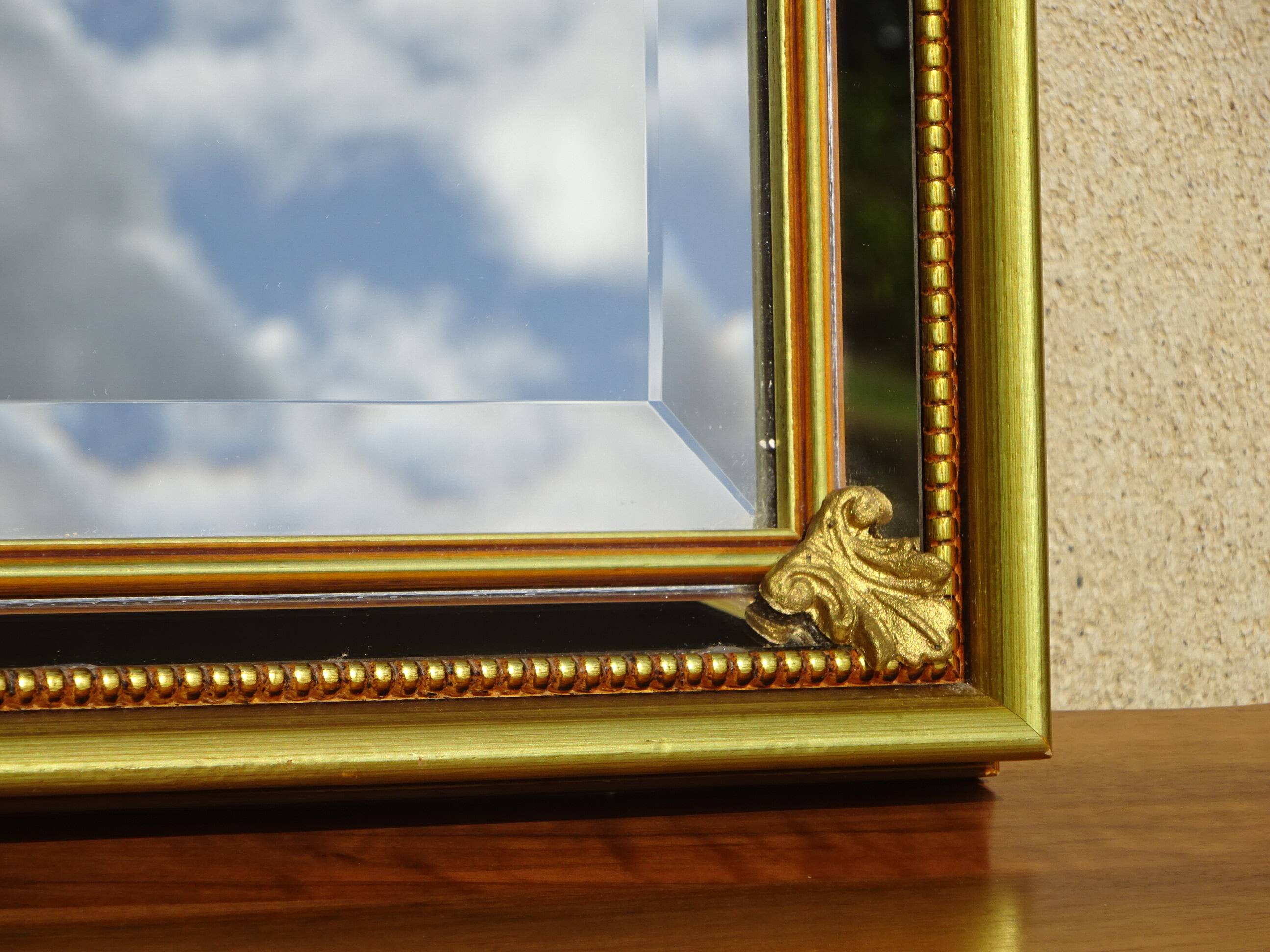 Vertical mirror, gold frame with beading.