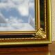 Vertical mirror, gold frame with beading.