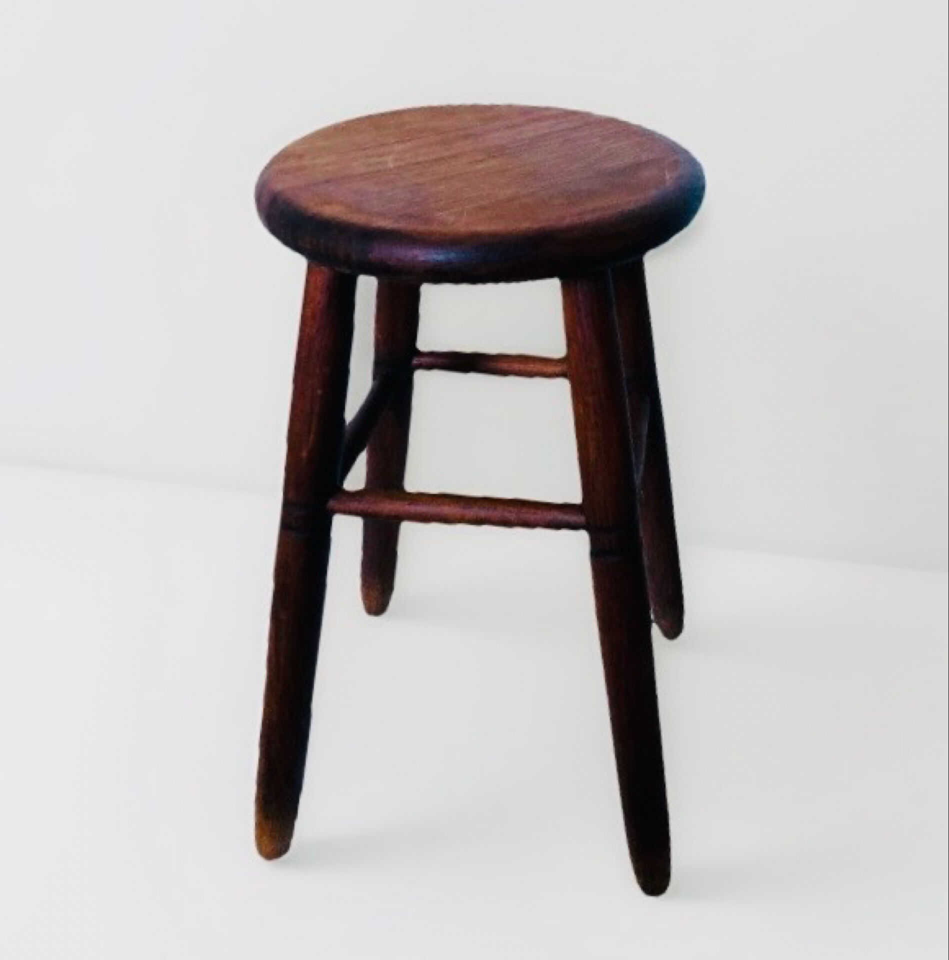 Vintage four-legged stool made of solid wood from the 1970s/80s.
