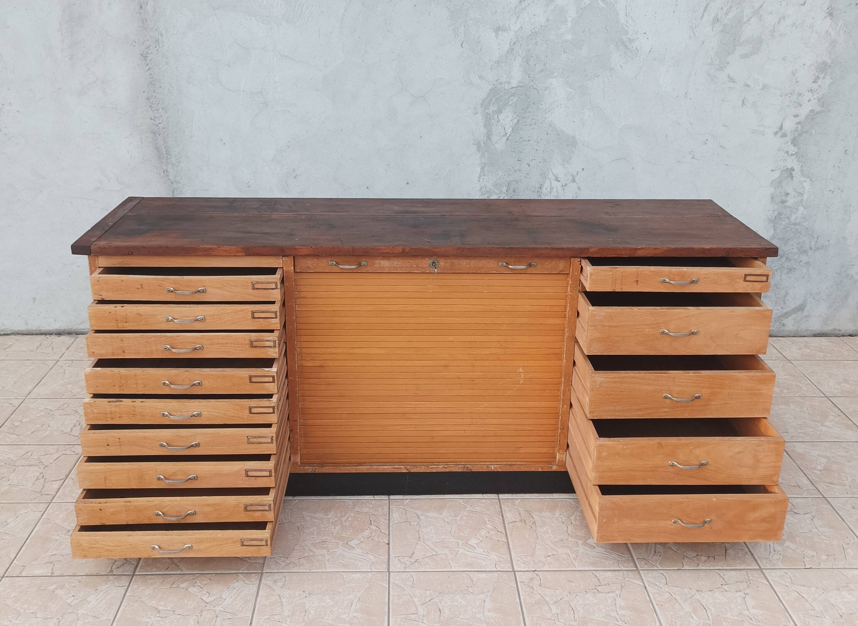 Workshop furniture with drawers and curtain in beech and walnut.