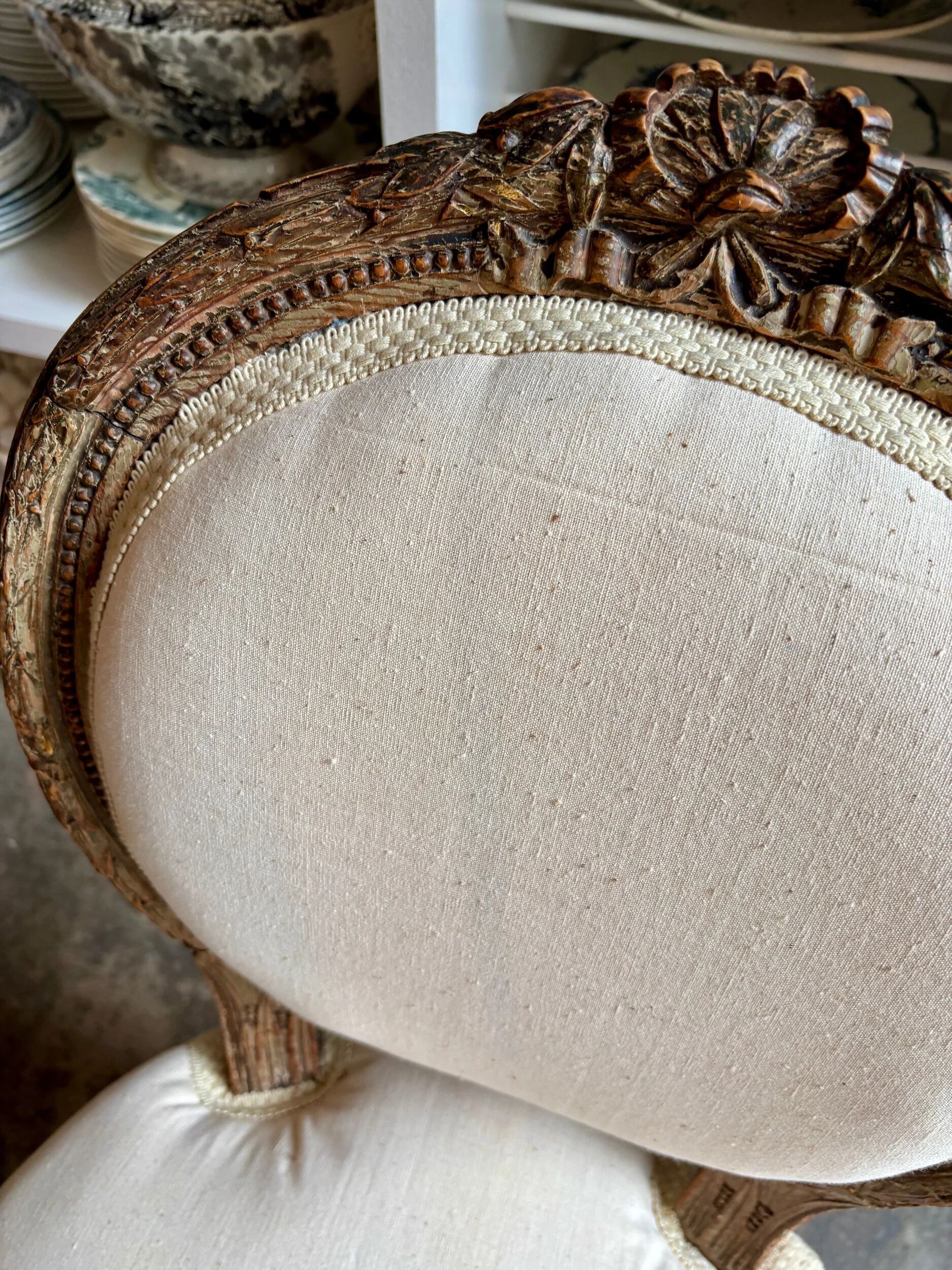 Medallion back chair in moulded wood and beige fabric.