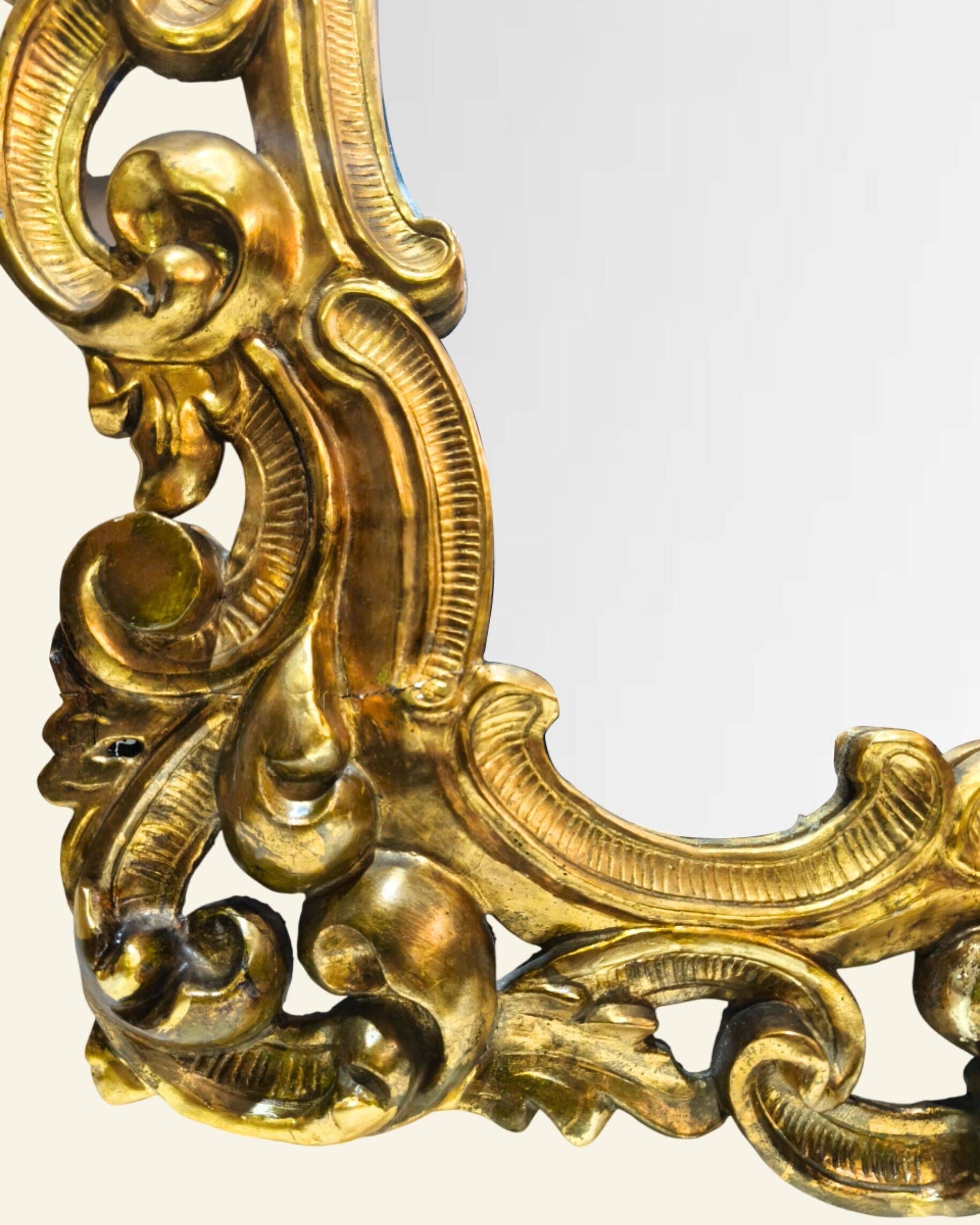 Antique wall mirror in carved and gilded wood, baroque style, 140 × 115 cm