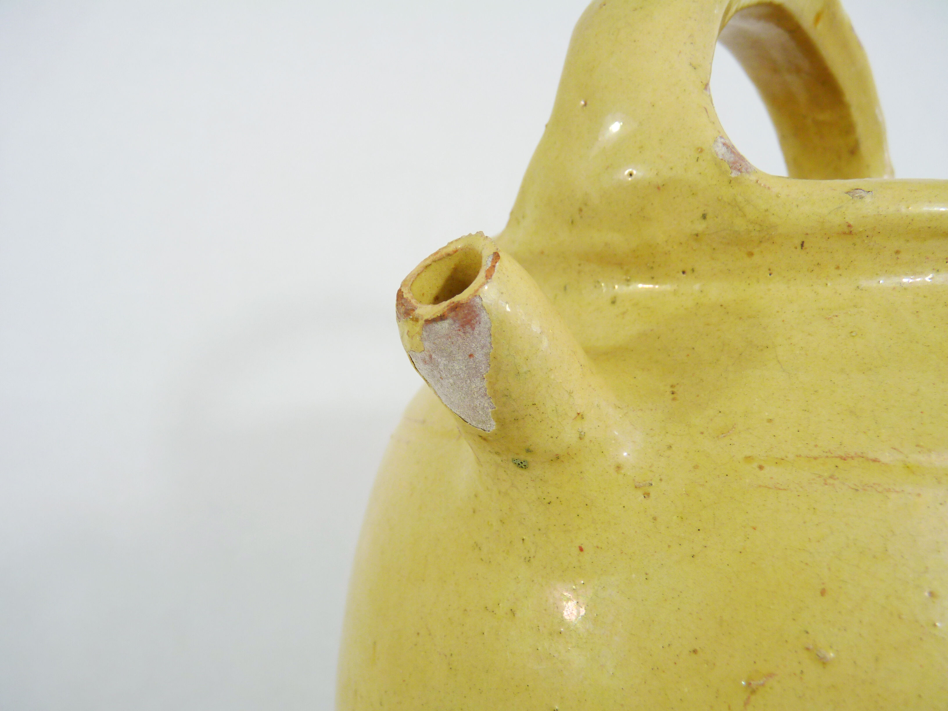 Old jug, chevrette, water pitcher in glazed yellow sandstone. Early twentieth century