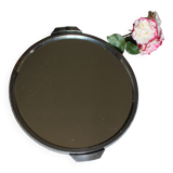 A large round mirror tray with metal handles