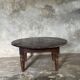 Coffee table, round antique Indonesian teak table with straight legs.