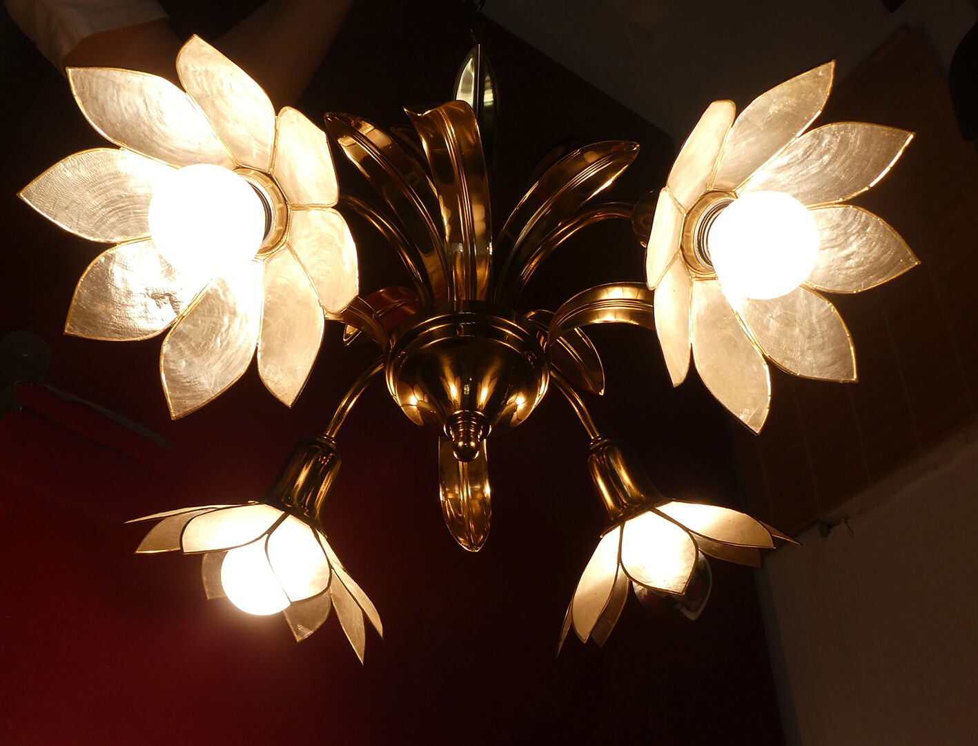 Brass chandelier and flowers in mother-of-pearl petals