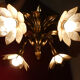 Brass chandelier and flowers in mother-of-pearl petals