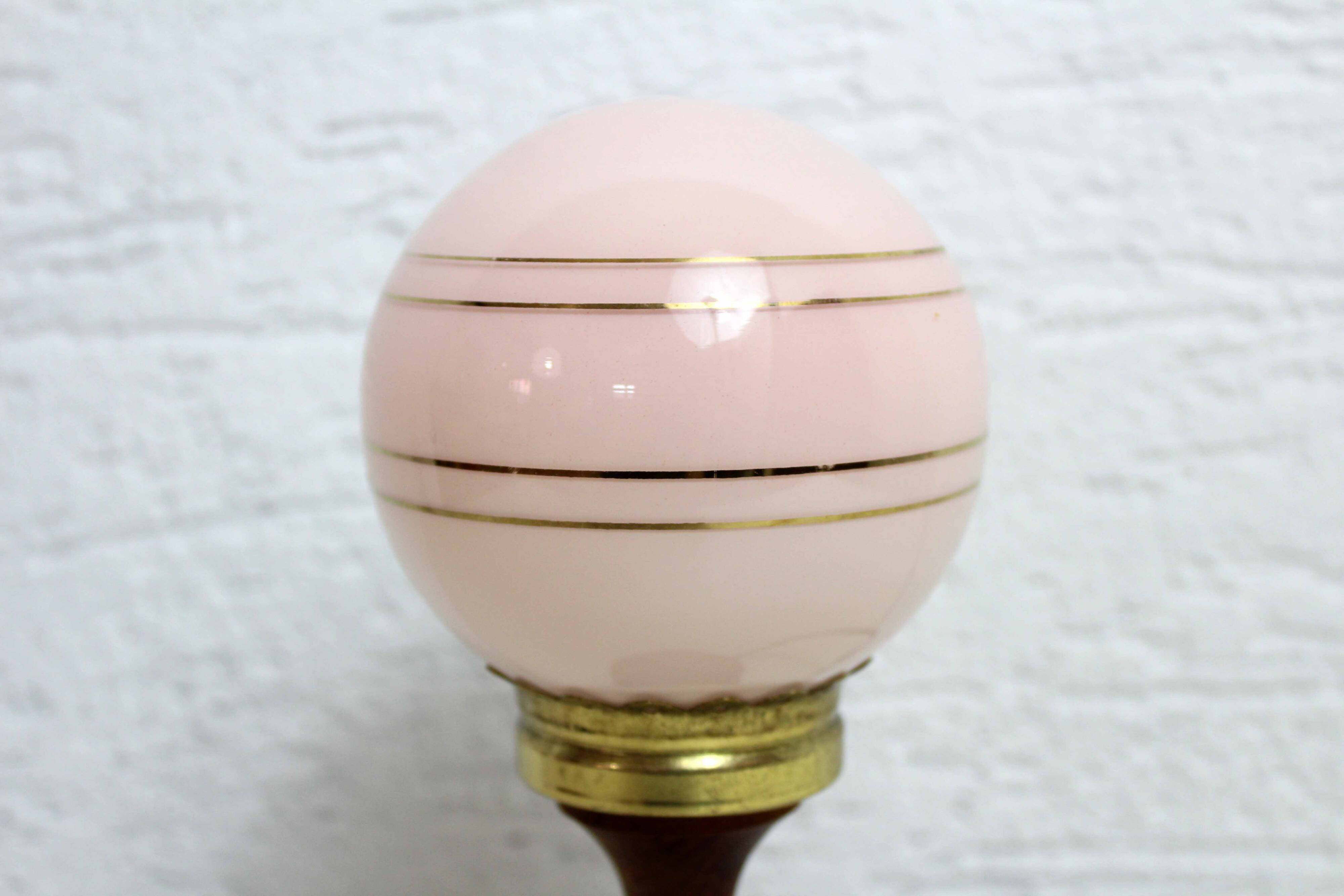 Turned wood and pink glass lamp