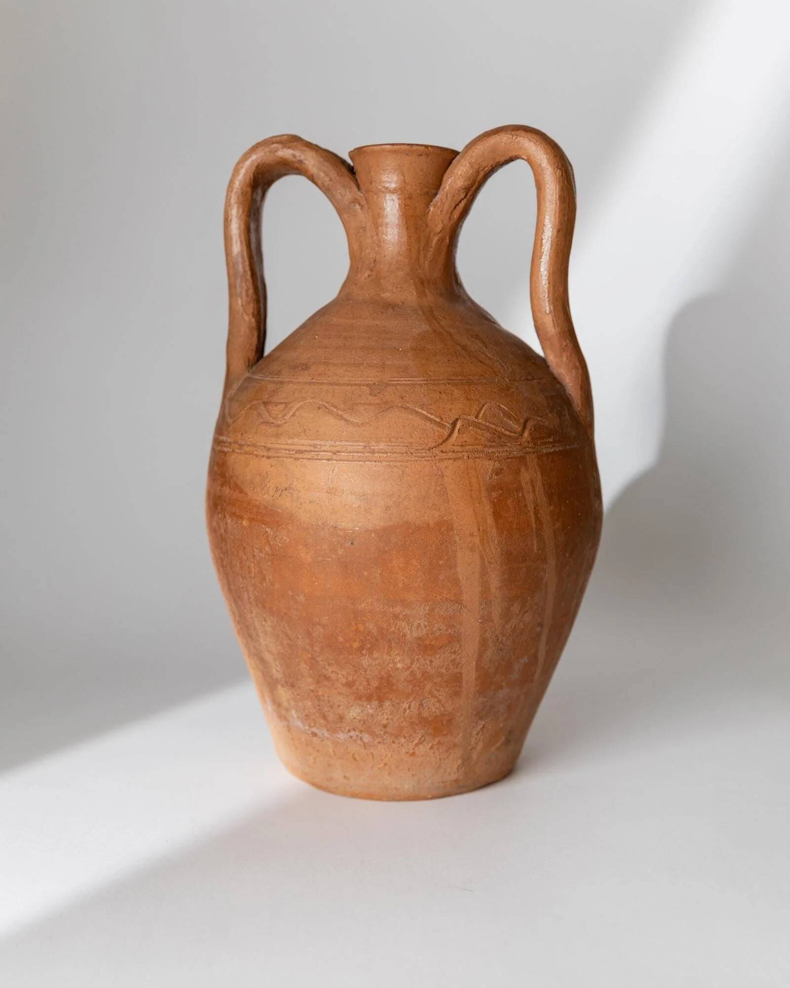 Vintage terracotta amphora vase from the early 19th century, handmade Italian jug with two handles.