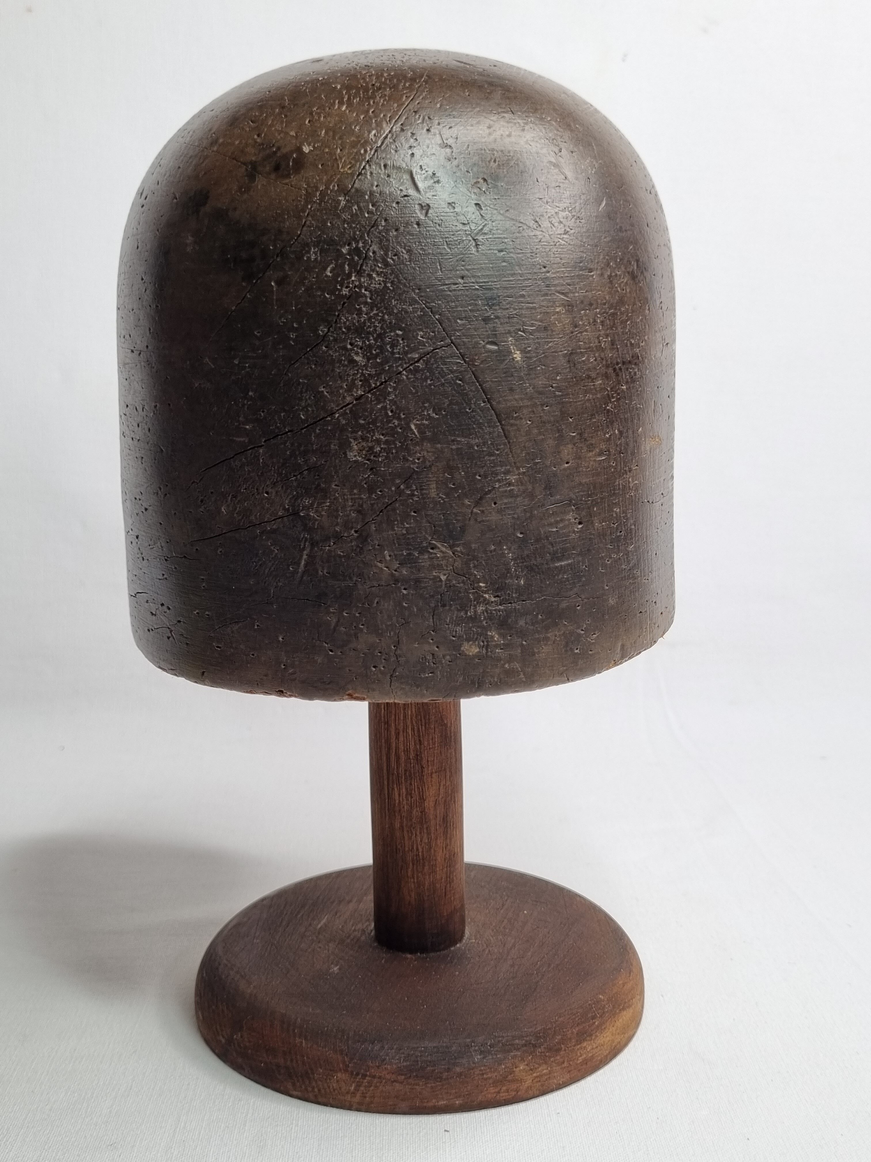 Old solid wood hat shape on foot, 1900