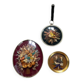 Trio of dried flower frames under curved glass