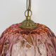 Vintage rose pendant light with pendants and patterned glass globe.