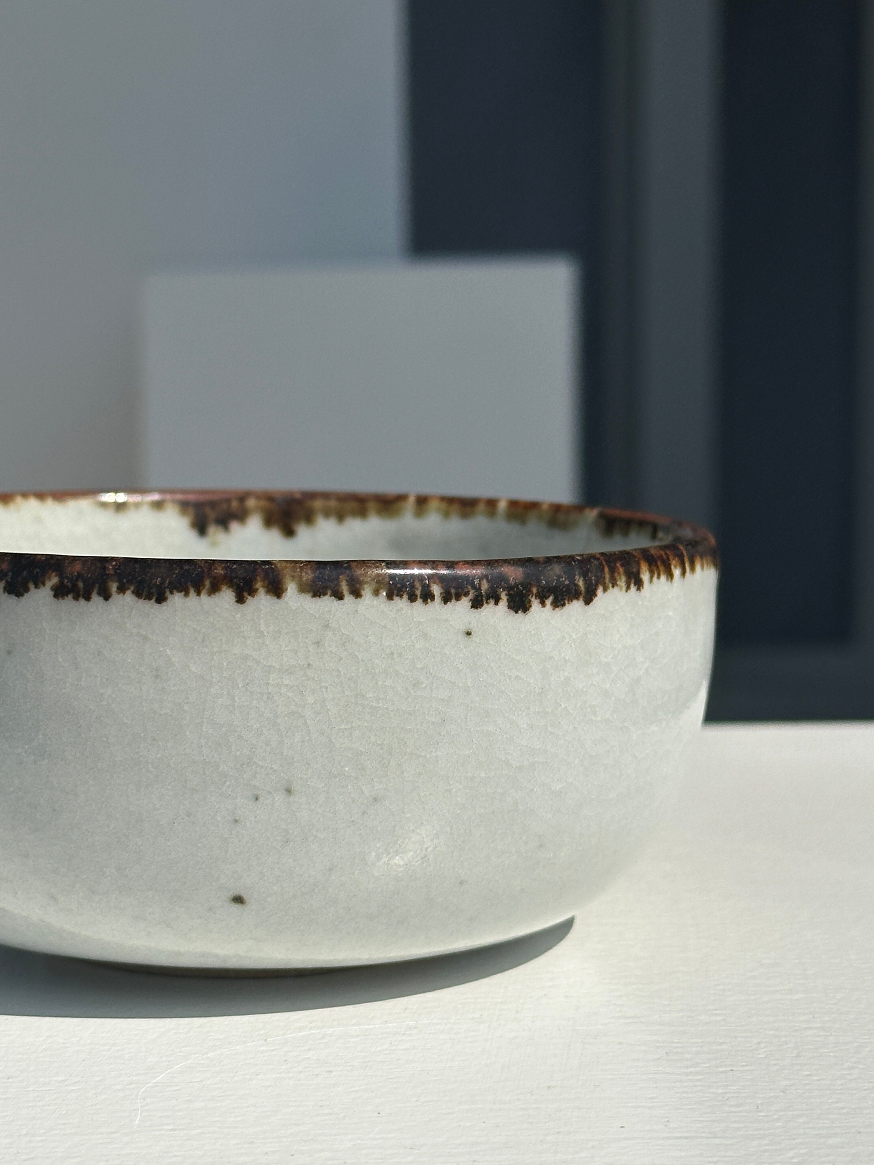 Small white glazed ceramic bowl black edges
