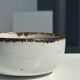 Small white glazed ceramic bowl black edges