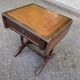 Small drop-leaf side table in English style with leather top & drawer.