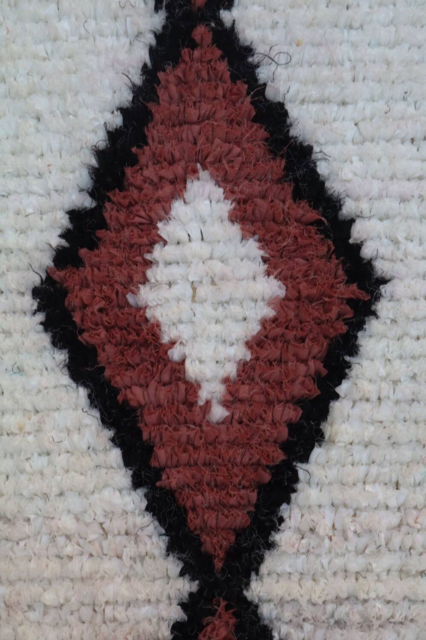 White Moroccan Boucherouite Berber rug with colorful patterns