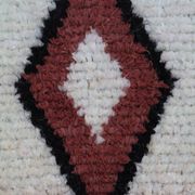 White Moroccan Boucherouite Berber rug with colorful patterns