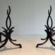 Pair of Wrought Iron Andirons with Stylised Flamboyant Uprights and Enrobed Feet