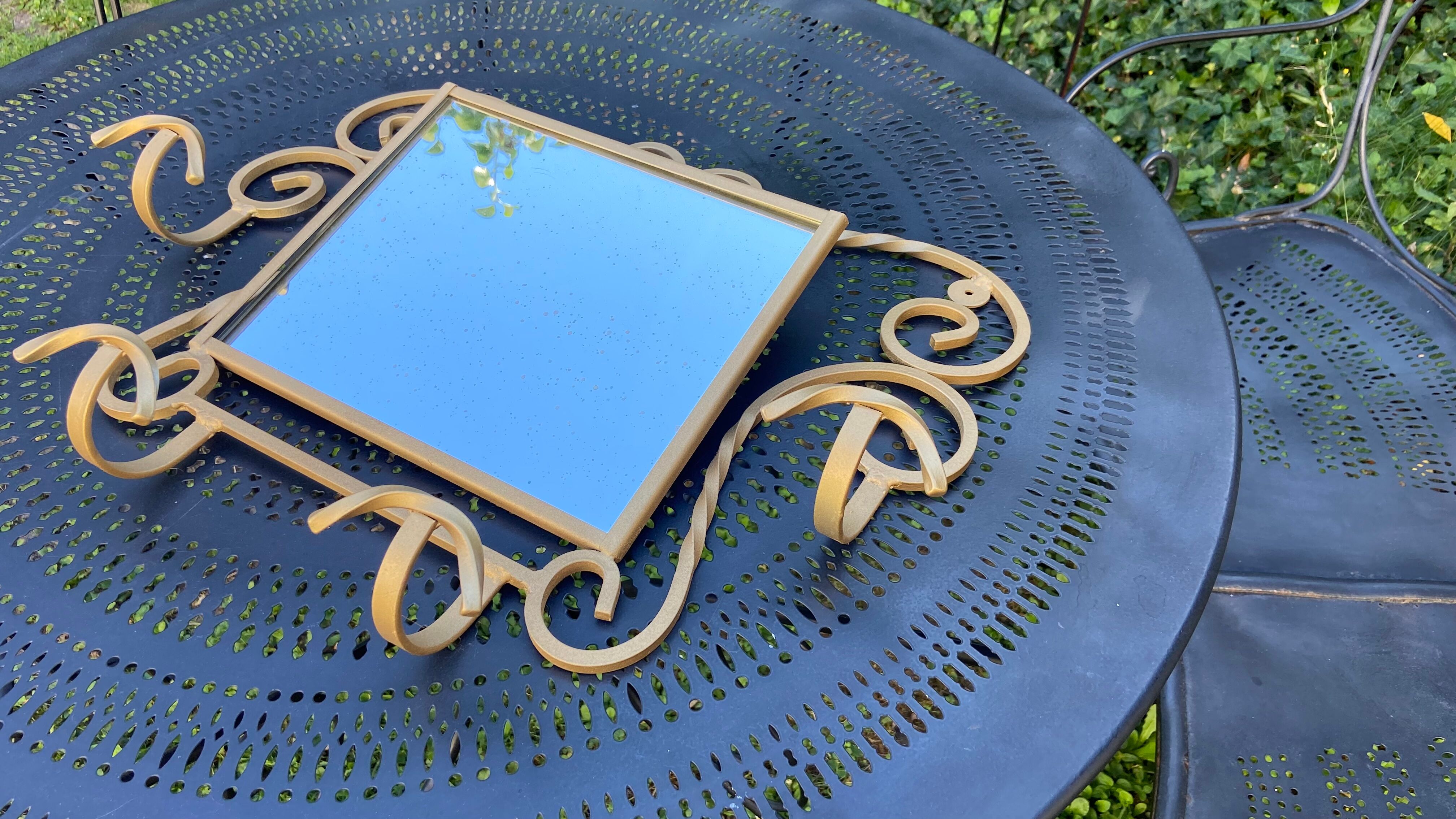 Wall-mounted gilded wrought iron coat rack with mirror