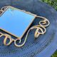 Wall-mounted gilded wrought iron coat rack with mirror