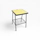 Small vintage yellow side table with magazine rack.