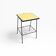 Small vintage yellow side table with magazine rack.