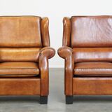 Set of 2 very comfortable large sheepskin armchairs elegantly finished with black piping