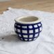 Vintage ceramic cache-pot with navy blue gingham pattern.
