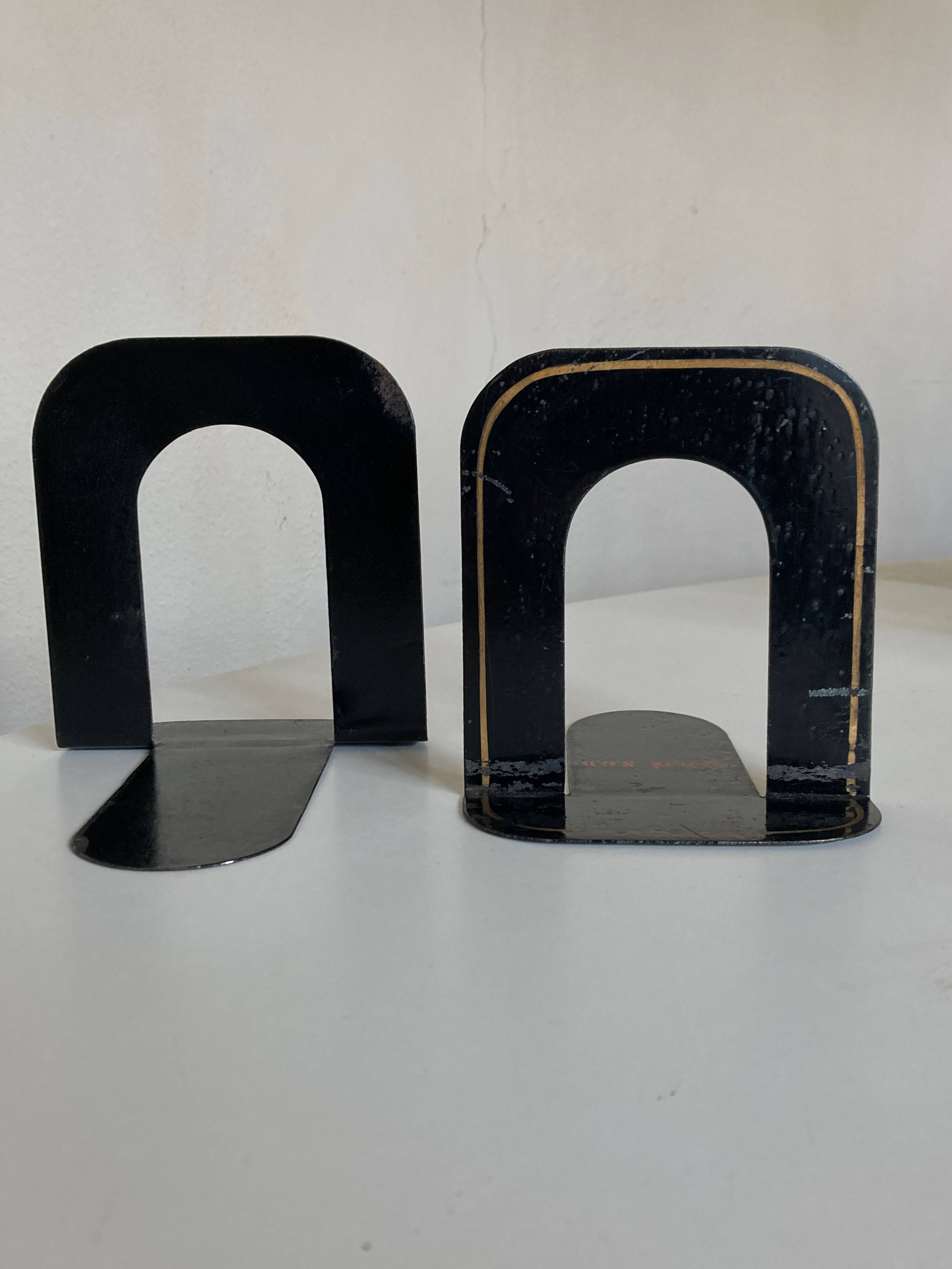 Pair of heavy metal bookends, folded, 1920.