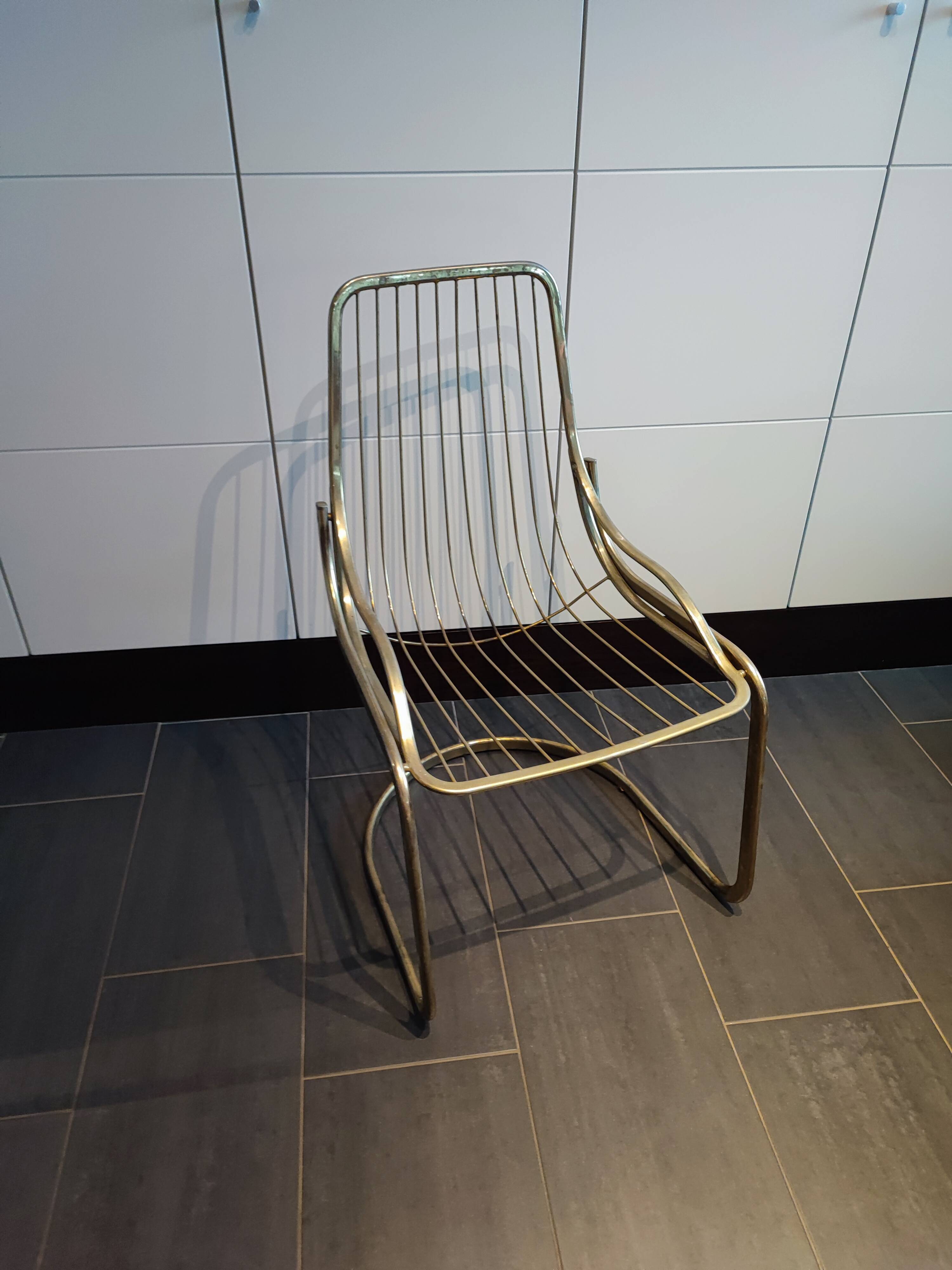 Tubular metal chair covered with gilding
