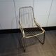 Tubular metal chair covered with gilding