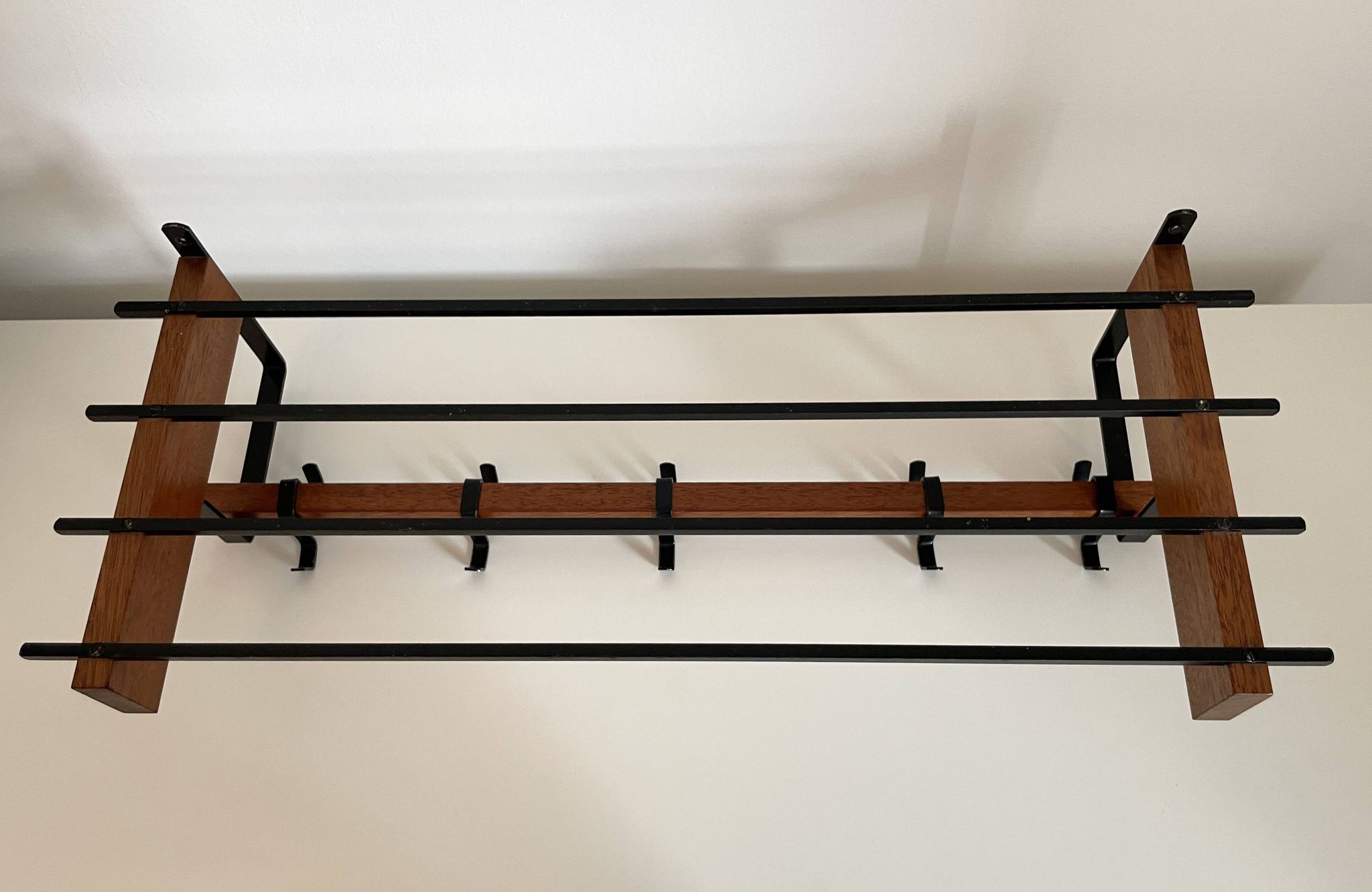 Vintage Scandinavian wall coat rack in wood and metal.