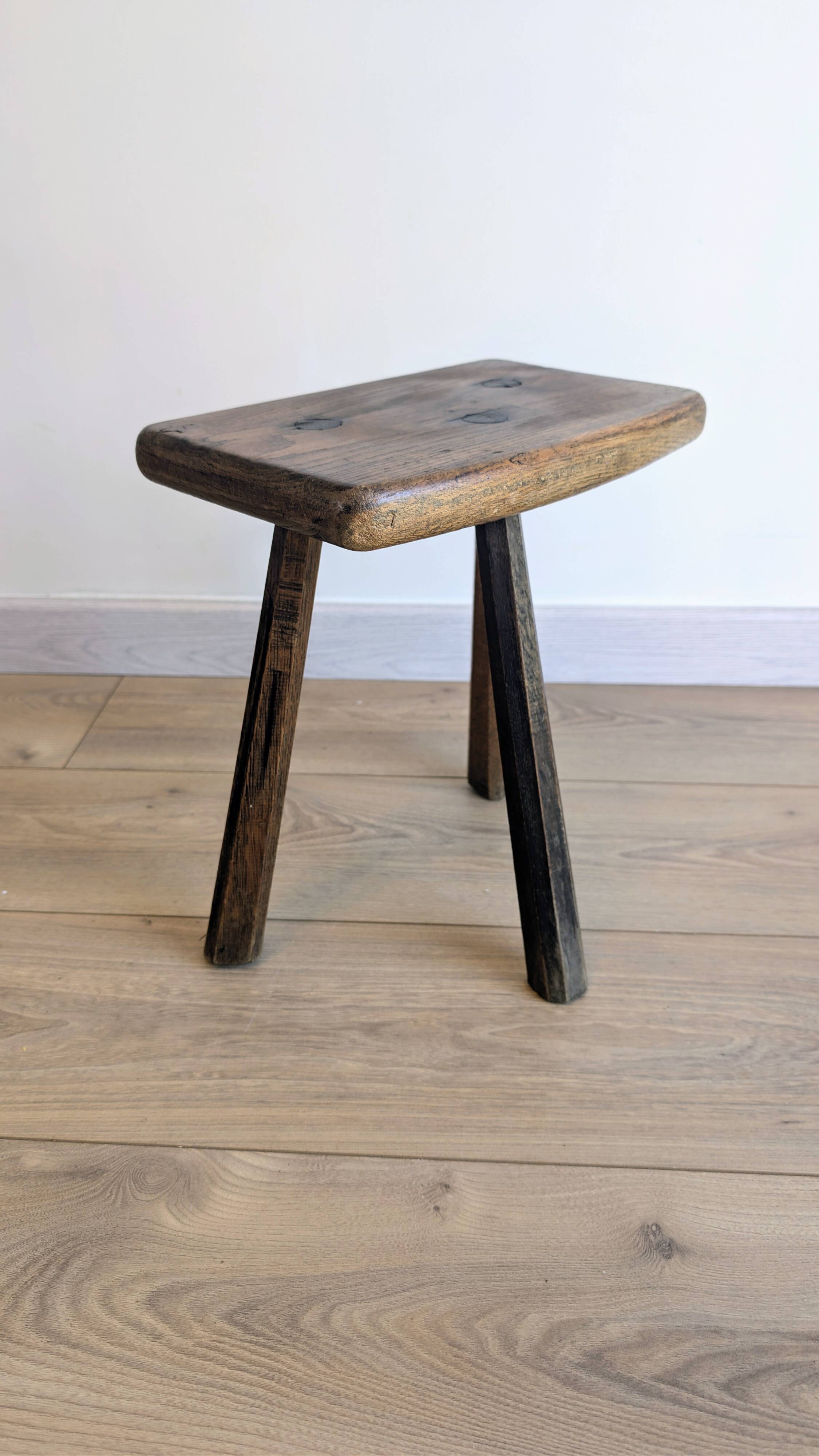 Antique tripod stool in patinated solid wood