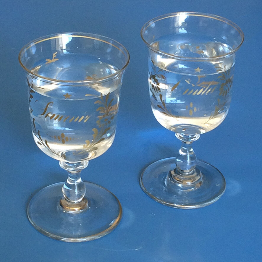 Two antique walking glasses with gold-painted floral decoration