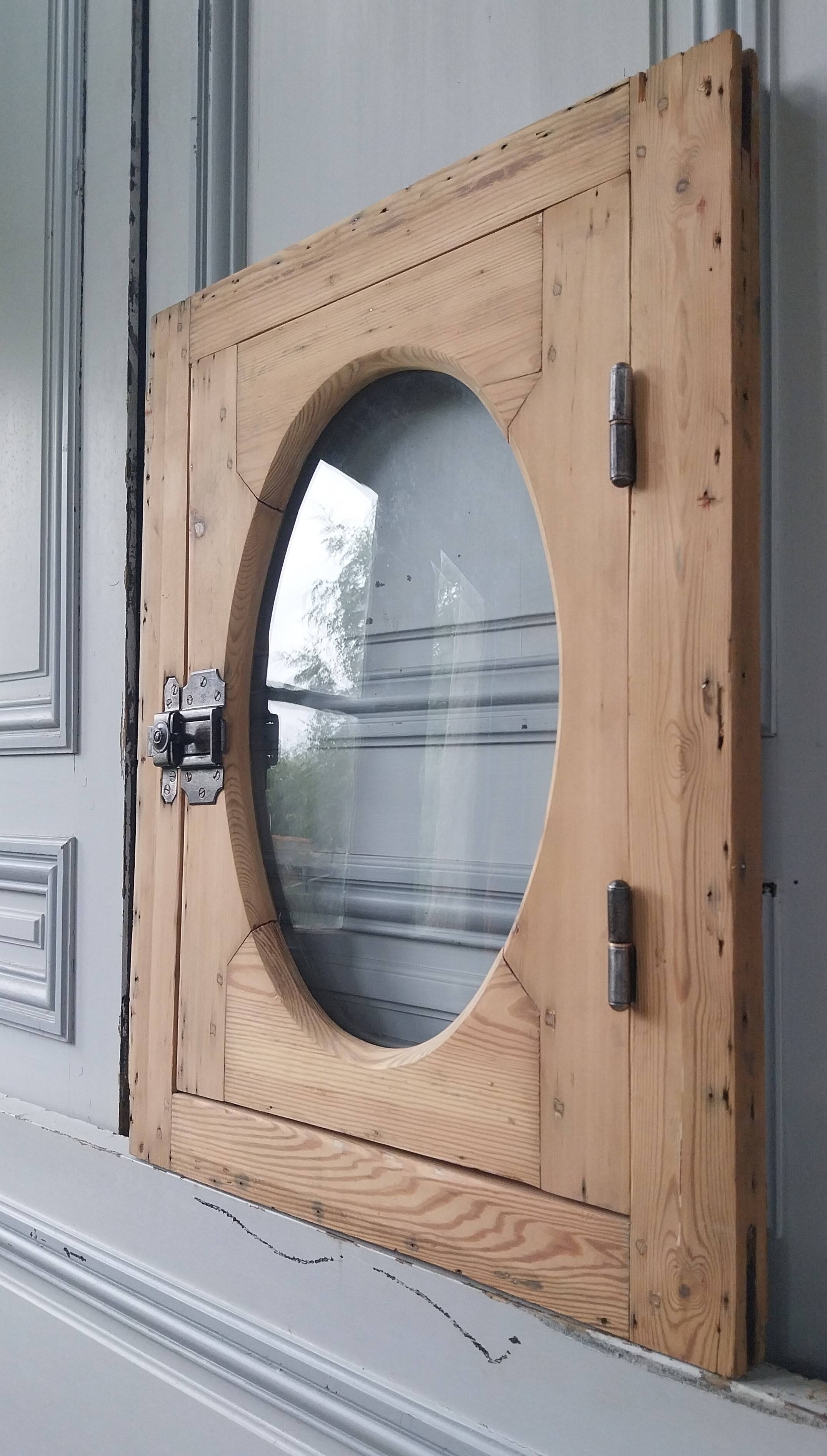 Old bullseye window with oval glass