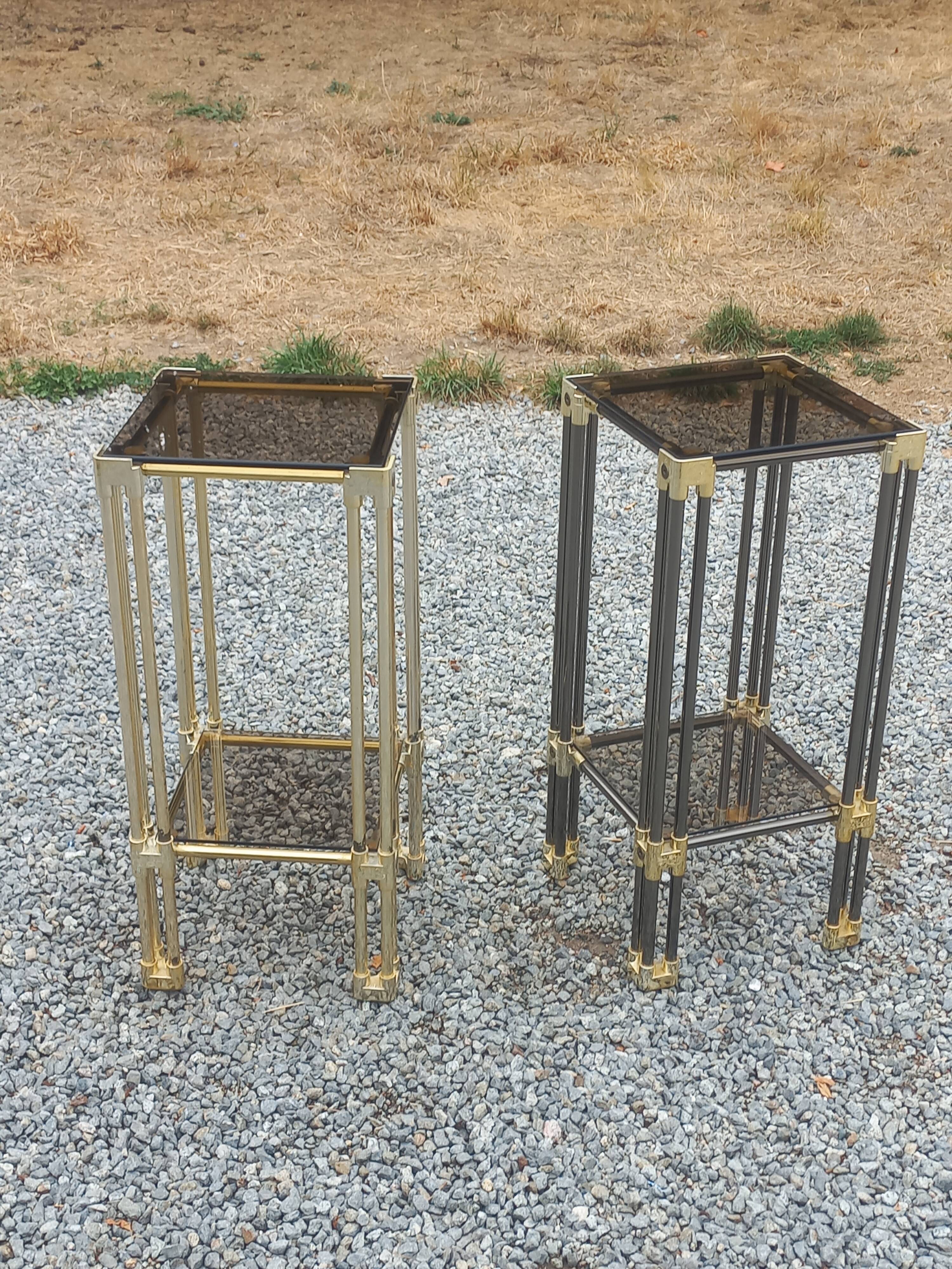 Pair of Hollywood Regency side tables in gold metal and smoked glass.