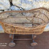 Old rattan cradle on wheels