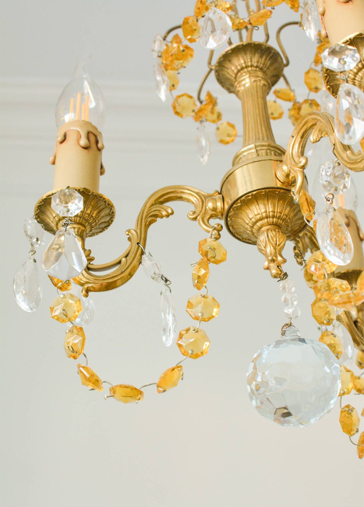Small vintage brass chandelier with amber crystal pendants.