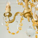 Small vintage brass chandelier with amber crystal pendants.