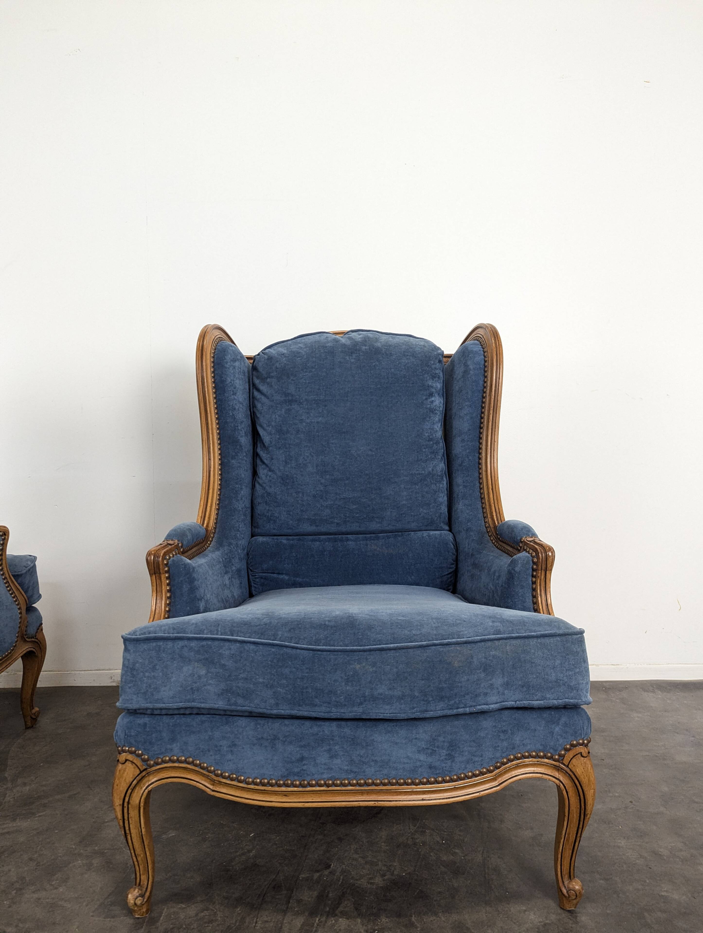 Pair of Louis XV style wingback armchairs in blue velvet.