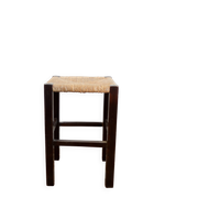 Vintage rustic stool in wood with a straw seat.