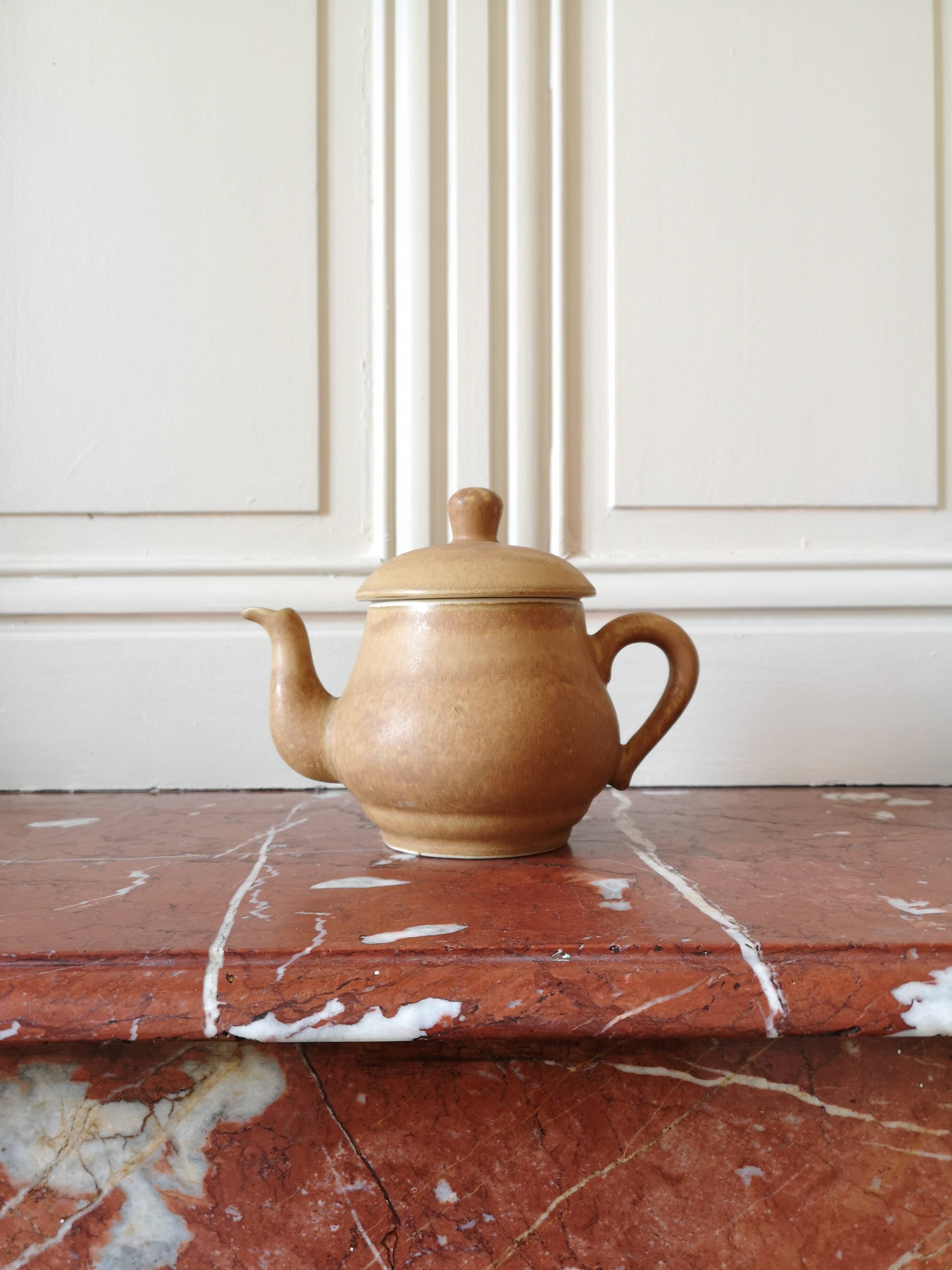 Vintage stoneware teapot and cup, "selfish" tea service, signed