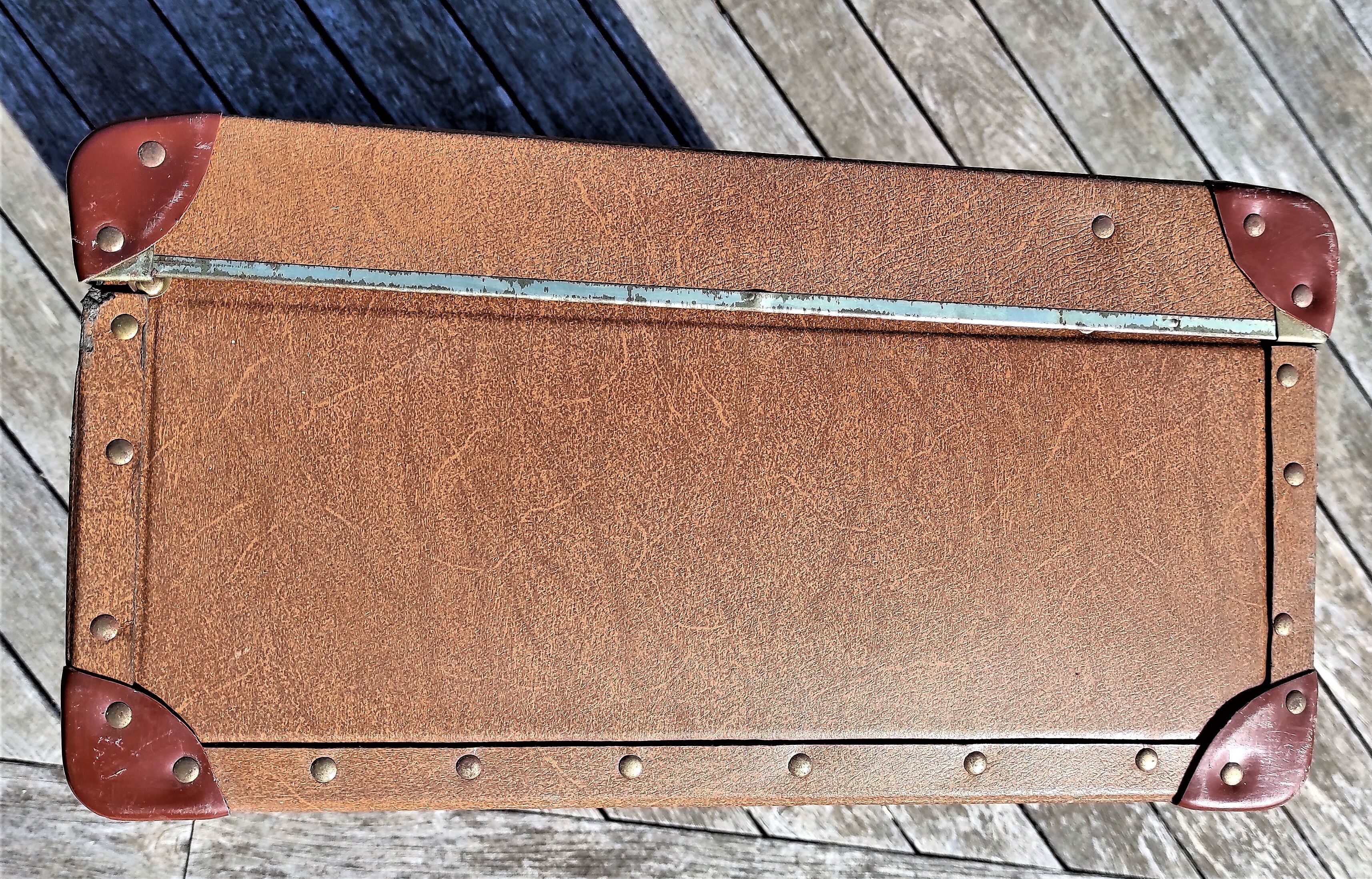 Brown vintage suitcase with CHENEY England brand travel tags