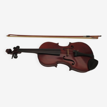 old children's violin with its bow and case