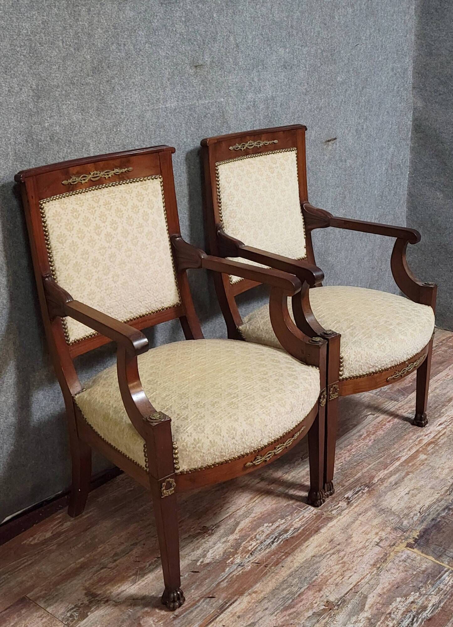 Pair of Empire period armchairs, in mahogany and gilded bronze.
