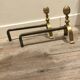 Neoclassical pine cone fireplace chenets in bronze